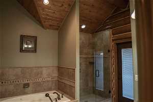 Master Bathroom featuring vaulted ceiling, wood ceiling, and independent shower and bath