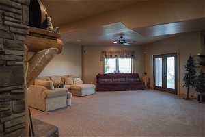 Living room featuring french doors, carpet, and ceiling fan