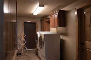 Washroom featuring cabinets and independent washer and dryer