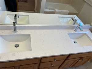 Double vanity with new quartz counters, sinks and faucets.