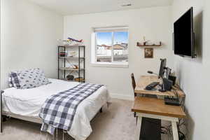 Bedroom with light colored carpet