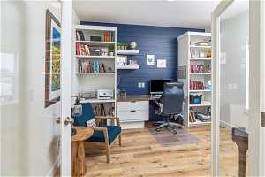 Home office featuring light LVP flooring / wood-style flooring and built in desk