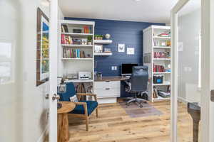 Home office featuring light LVP flooring / wood-style flooring and built in desk