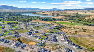 Drone / aerial view featuring a water and mountain view