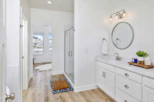 Master bathroom featuring walk in shower, vanity, and walk in closet