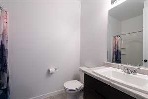 Main floor Bathroom featuring Shower, vanity, toilet,