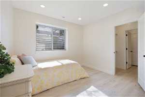 1 of 2 basement apatment / flex area - Bedroom with light hardwood / wood-style flooring