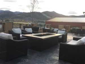 View of patio with an outdoor living space with a fire pit and a mountain view