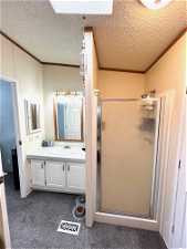 Master bath with large tub and separate shower. Skylight provides natural light.