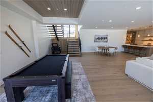 Playroom with billiards and hardwood / wood-style flooring