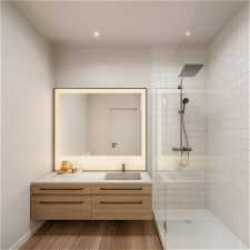 Bathroom featuring dual bowl vanity, walk in shower, and hardwood / wood-style floors