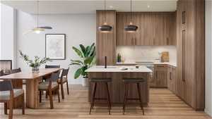 Kitchen featuring a kitchen island, pendant lighting, light wood-type flooring, and ceiling fan