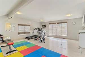 Exercise room with light tile floors