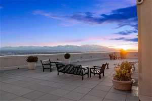 Patio terrace at dusk featuring a mountain view
