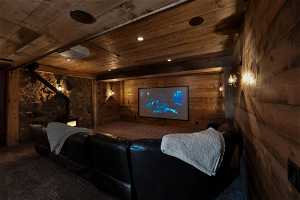 Carpeted cinema with wooden walls and wooden ceiling