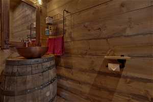 Bathroom featuring wooden walls and sink