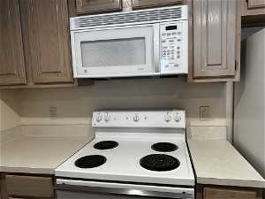 Kitchen microwave and electric stove.
