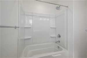 Bathroom featuring washtub / shower combination