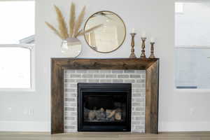 Interior details featuring a fireplace and wood-type flooring