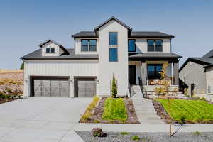 View of front of property featuring a porch and a garage