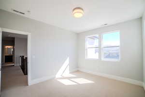 Empty room with light colored carpet