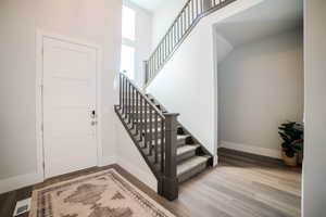 Stairs with hardwood / wood-style floors