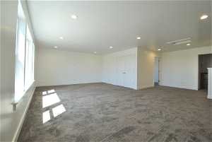 Family room with dark colored carpet