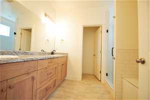 Primary bathroom with double vanity separate tub shower and a private throne room.