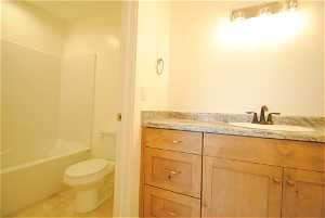 Full bathroom featuring vanity, storage and a separate toilet shower / bathing tub combination