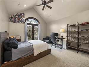 Bedroom featuring access to outside, light carpet, high vaulted ceiling, and ceiling fan