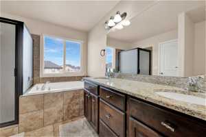 Master Bathroom with independent shower and deep bath, double sink vanity, tile floors and walk-in closet.