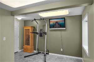 Workout room featuring light tile flooring
