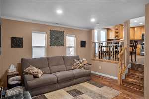 Living room with crown molding and hardwood / wood-style floors