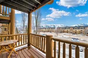 Front covered deck with a mountain view
