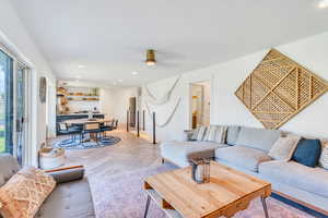 Living room featuring ceiling fan and light parquet flooring