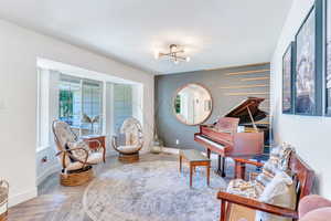 Living area featuring a notable chandelier and light parquet floors