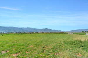 Property view of mountains with a rural view