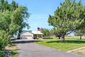 Ranch-style home with a garage and a front yard