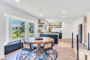 Dining area featuring sink and light parquet floors