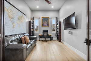 Living room featuring light wood-type flooring and ceiling fan