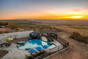 Pool at dusk featuring a patio area