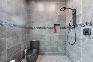 Bathroom with a tile shower and toilet