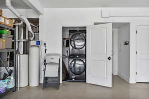 Utility room featuring stacked washer / dryer