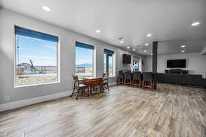 Dining area with light hardwood / wood-style flooring