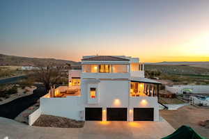 View of front of house with a mountain view and a patio