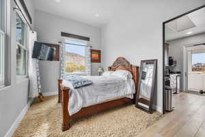 Bedroom featuring light hardwood / wood-style flooring and multiple windows