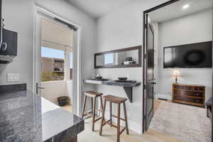 Kitchen featuring light wood-type flooring and a breakfast bar