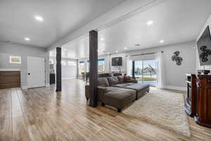 Living room featuring light hardwood / wood-style floors and ornate columns