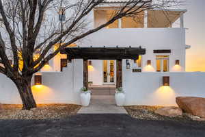 Exterior entry at dusk with french doors