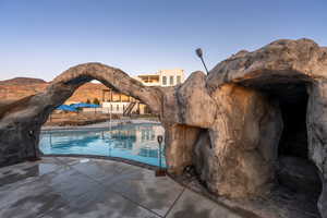 View of pool with a mountain view and a patio